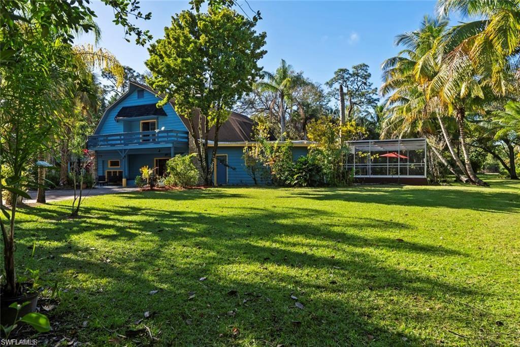3550 Hazel Road Naples, FL 34104 - Photo 30 of 43 a front view of a house with a yard