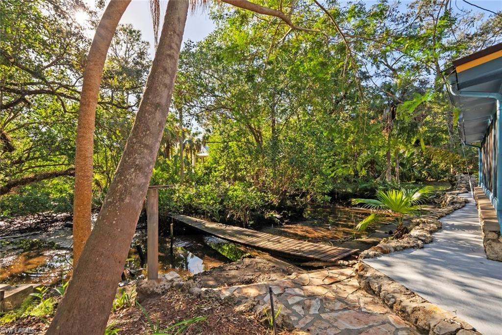 3550 Hazel Road Naples, FL 34104 - Photo 36 of 43 a backyard of a house with lots of green space