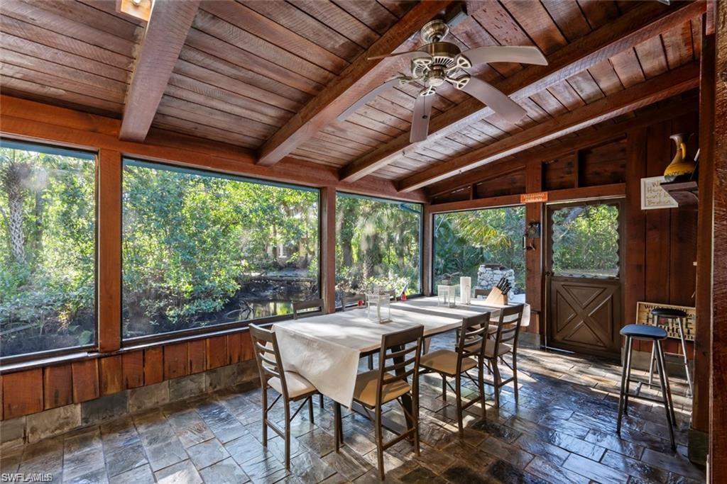 3550 Hazel Road Naples, FL 34104 - Photo 8 of 43 a dining room with furniture water view and a backyard of a house
