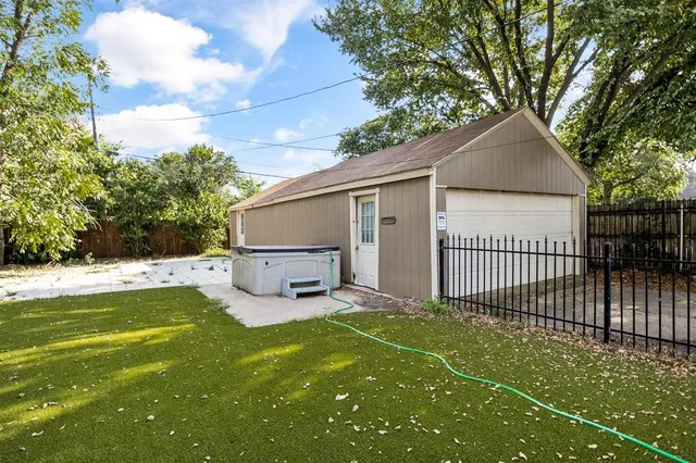 a view of a backyard with a large tree