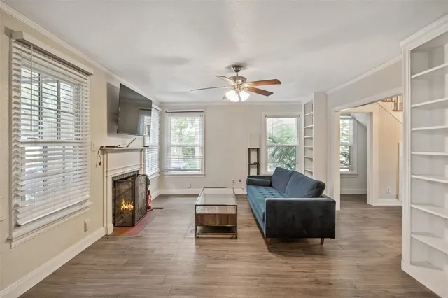 a living room with furniture a fireplace and a flat screen tv
