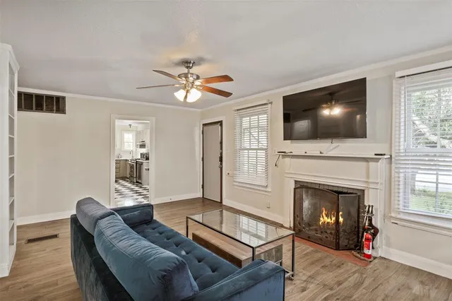 a living room with furniture a fireplace and a flat screen tv