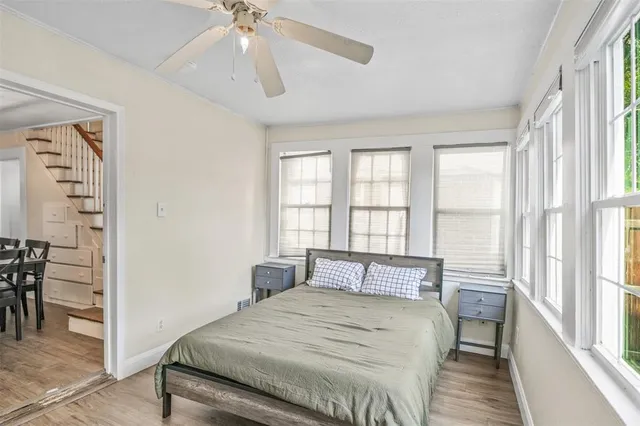 a bedroom with a large bed and a chandelier