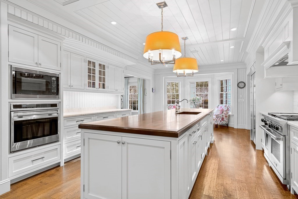 15 Valley Road Wellesley, MA 02481 - Photo 15 of 42 a kitchen with stainless steel appliances a stove a sink a chimney and a center island