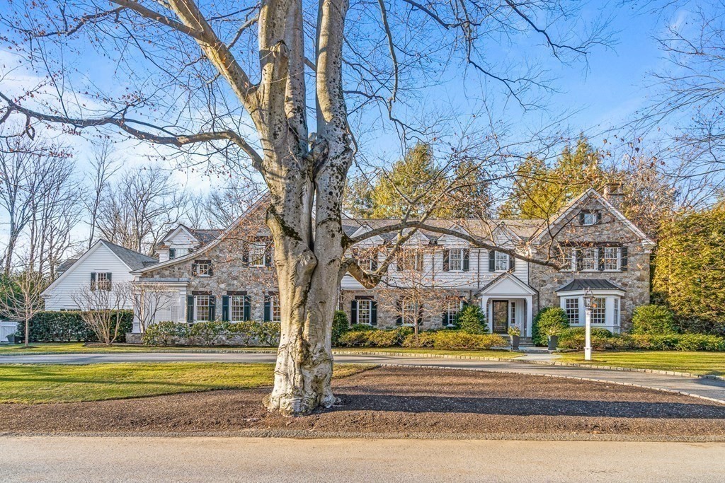 15 Valley Road Wellesley, MA 02481 - Photo 2 of 42 a view of a big house with large trees and plants next to road