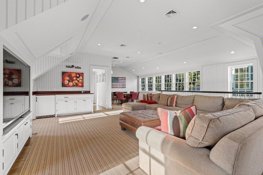 15 Valley Road Wellesley, MA 02481 - Photo 36 of 42 a living room with furniture and a flat screen tv