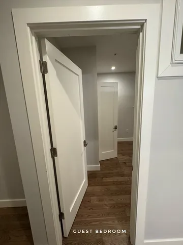 a view of hallway with wooden floor