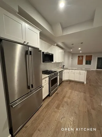 a kitchen with stainless steel appliances a refrigerator sink and stove