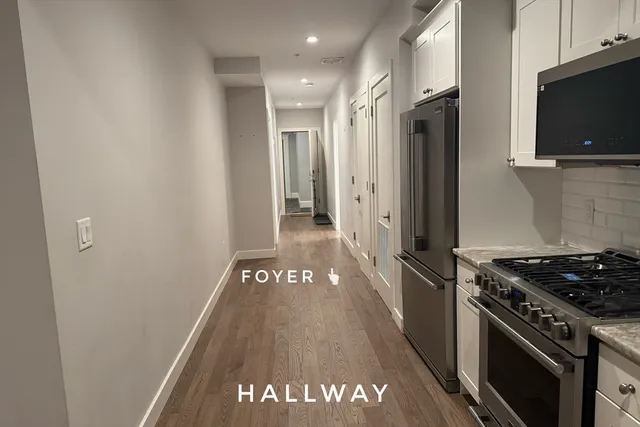 a kitchen with stainless steel appliances a stove a refrigerator and a microwave