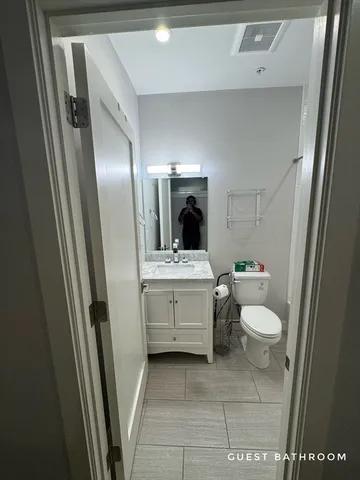 a bathroom with a sink a toilet and mirror