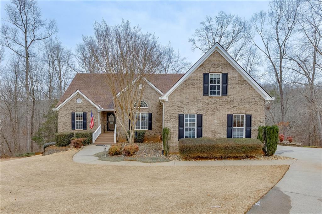 a view of a house with a yard covered in snow