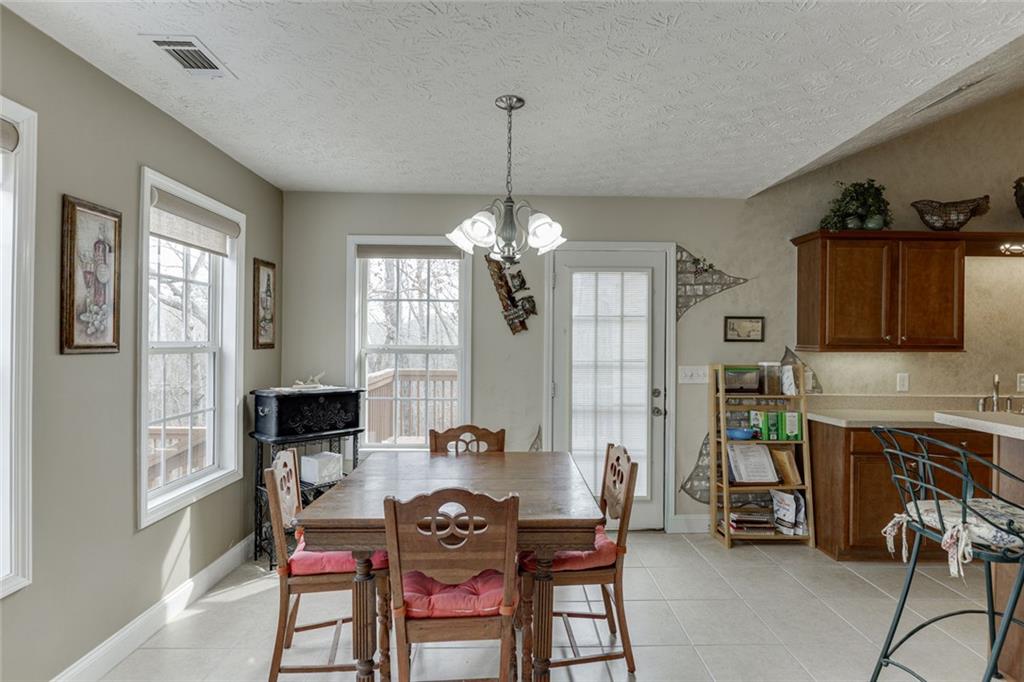 124 Edgewater Court Braselton, GA 30517 - Photo 15 of 54 a view of a a dining room with furniture window and wooden floor