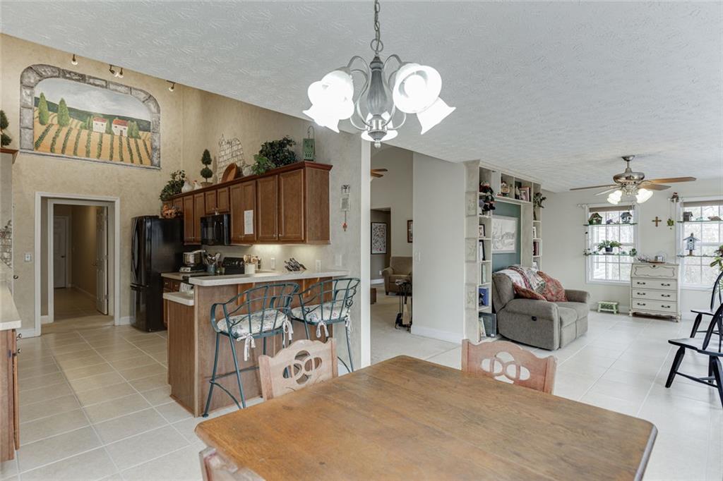 124 Edgewater Court Braselton, GA 30517 - Photo 17 of 54 a view of kitchen with sink refrigerator dining table and chairs