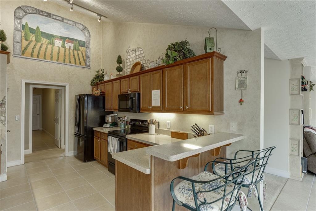 124 Edgewater Court Braselton, GA 30517 - Photo 19 of 54 a kitchen with a sink refrigerator and cabinets