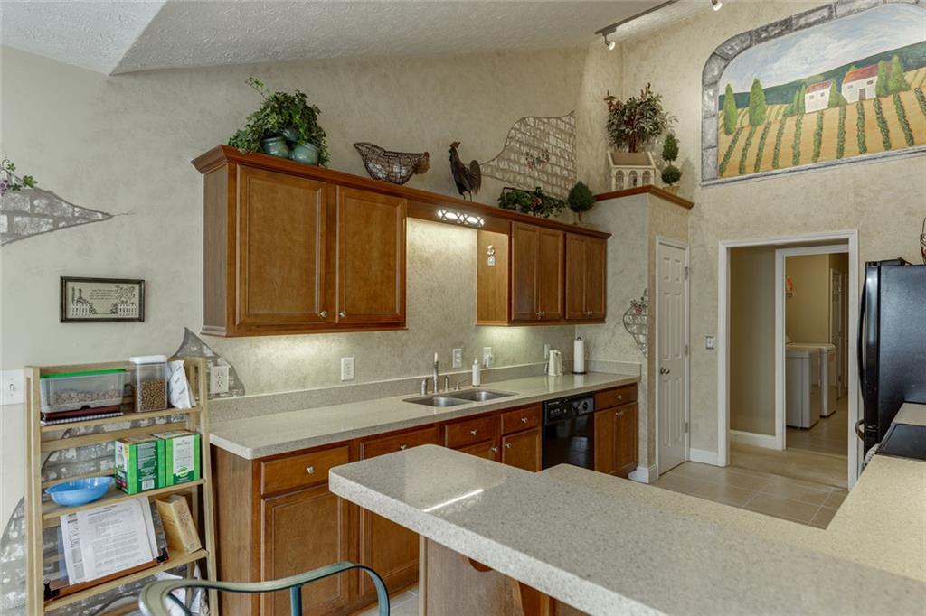 124 Edgewater Court Braselton, GA 30517 - Photo 20 of 54 a kitchen with a table chairs sink and cabinets