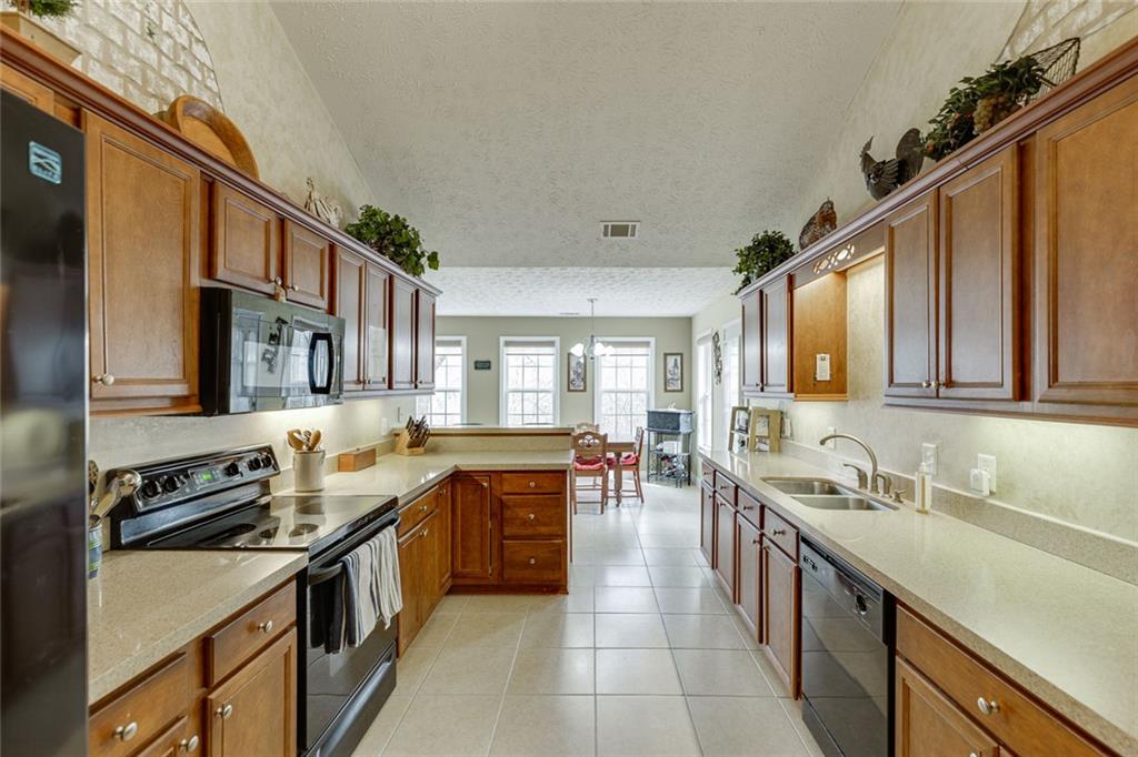 124 Edgewater Court Braselton, GA 30517 - Photo 21 of 54 a kitchen with stainless steel appliances granite countertop a sink stove and cabinets