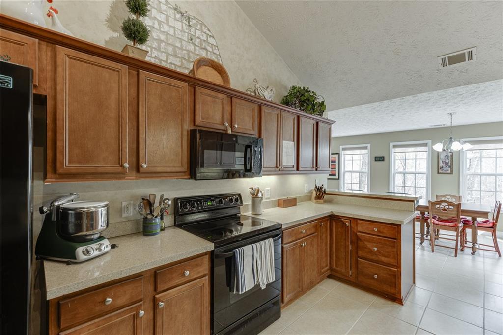 124 Edgewater Court Braselton, GA 30517 - Photo 22 of 54 a kitchen with stainless steel appliances granite countertop a sink stove and microwave