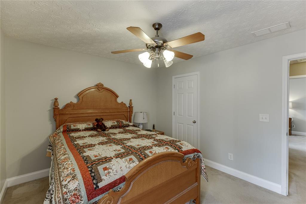 124 Edgewater Court Braselton, GA 30517 - Photo 26 of 54 a bedroom with a bed and a chandelier
