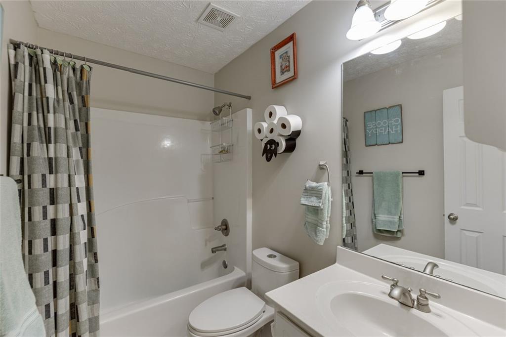 124 Edgewater Court Braselton, GA 30517 - Photo 27 of 54 a bathroom with a sink toilet and shower