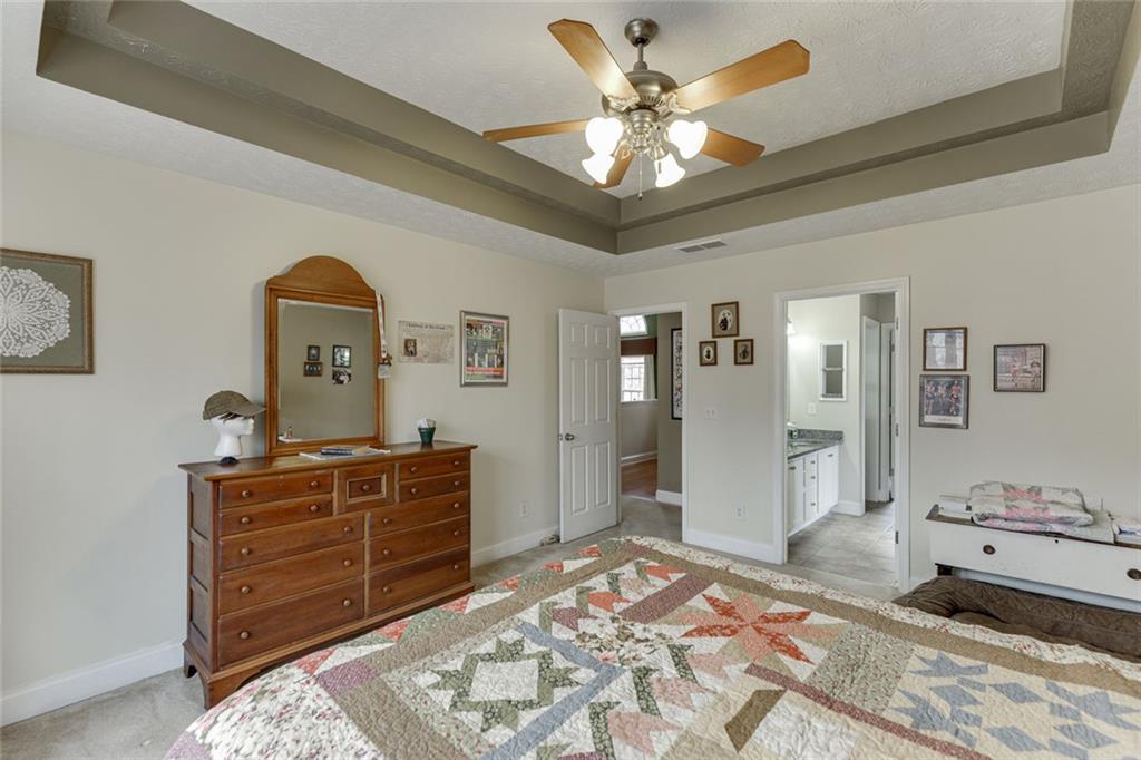 124 Edgewater Court Braselton, GA 30517 - Photo 36 of 54 a bedroom with a bed and a dresser