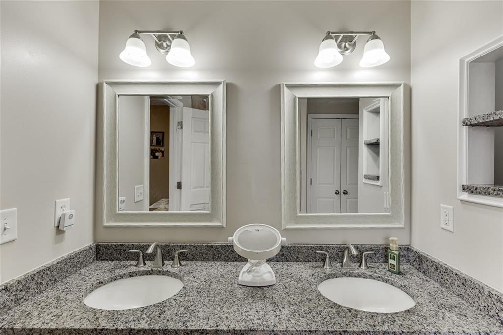 124 Edgewater Court Braselton, GA 30517 - Photo 38 of 54 a bathroom with double sink and a mirror