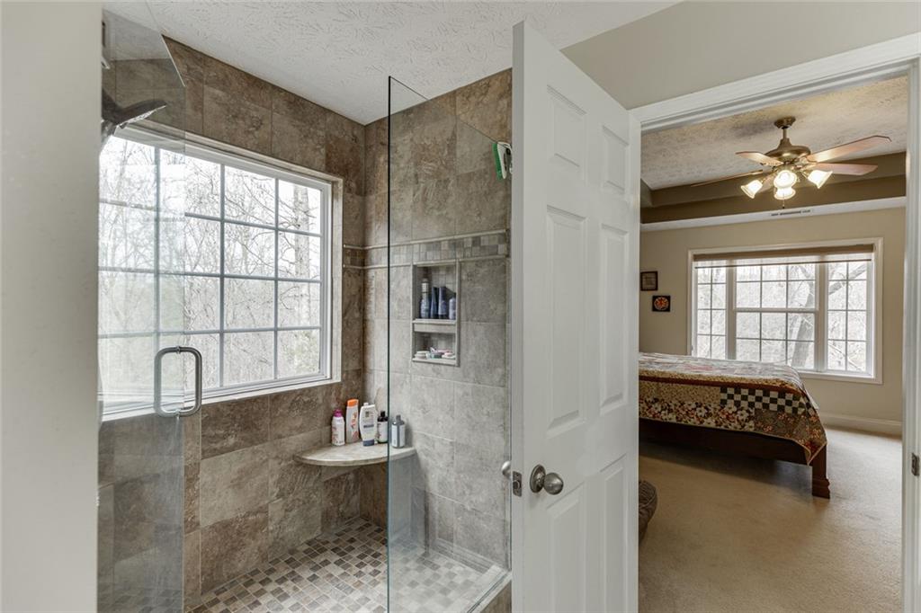 124 Edgewater Court Braselton, GA 30517 - Photo 39 of 54 a living room with furniture and a large window