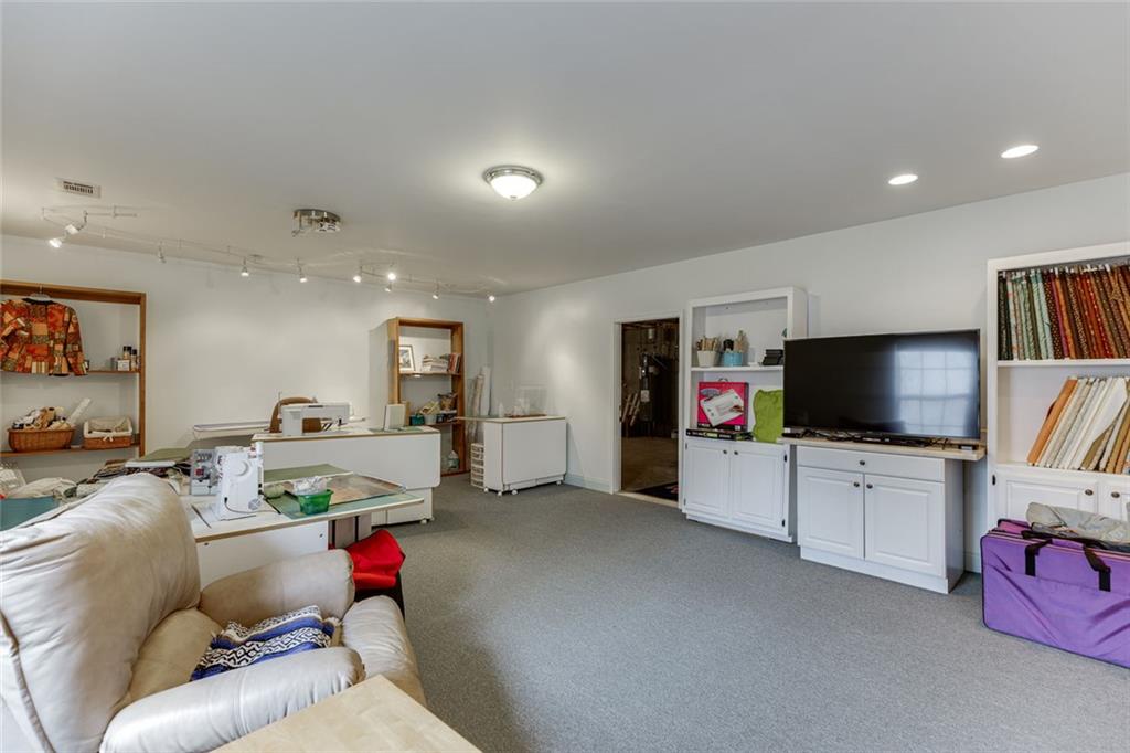 124 Edgewater Court Braselton, GA 30517 - Photo 44 of 54 a living room with furniture and a flat screen tv