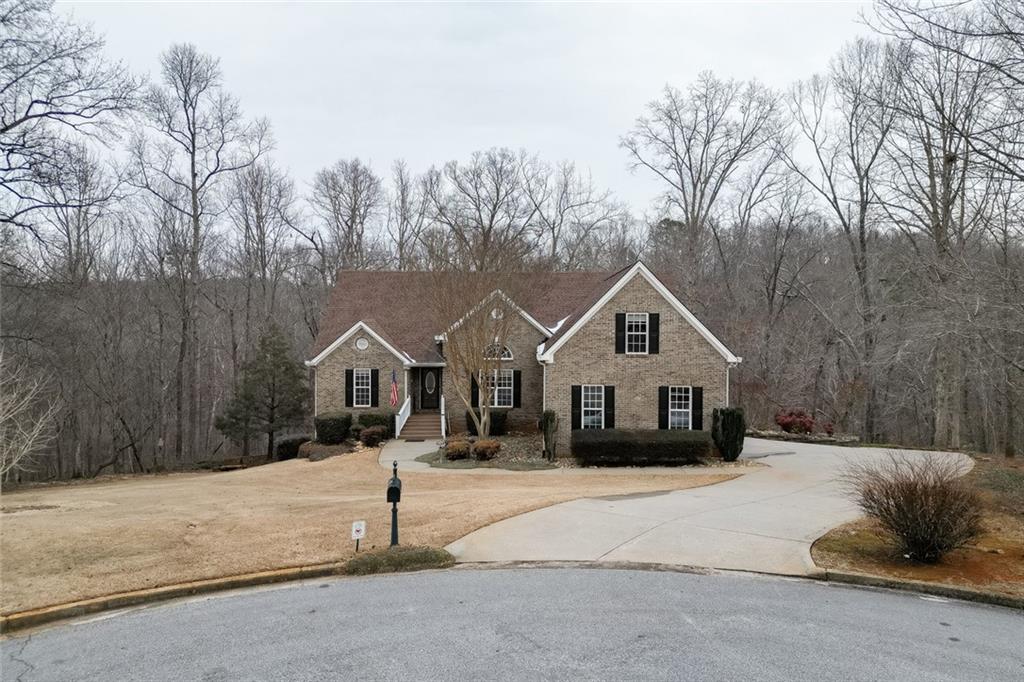 124 Edgewater Court Braselton, GA 30517 - Photo 50 of 54 a front view of a house with a yard covered in snow