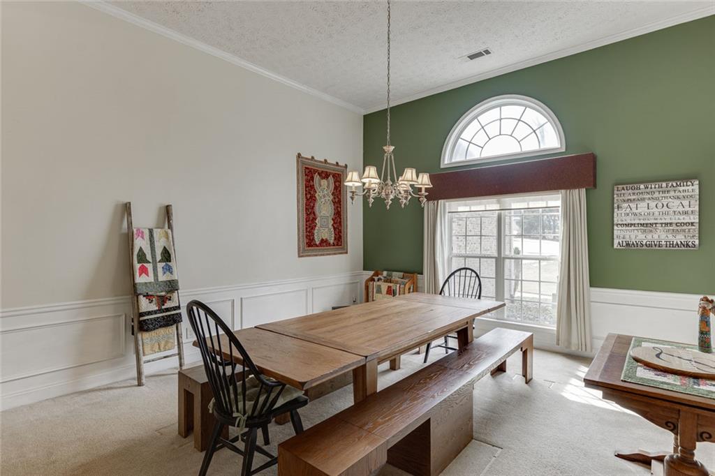 124 Edgewater Court Braselton, GA 30517 - Photo 5 of 54 a dining room with furniture a chandelier and window