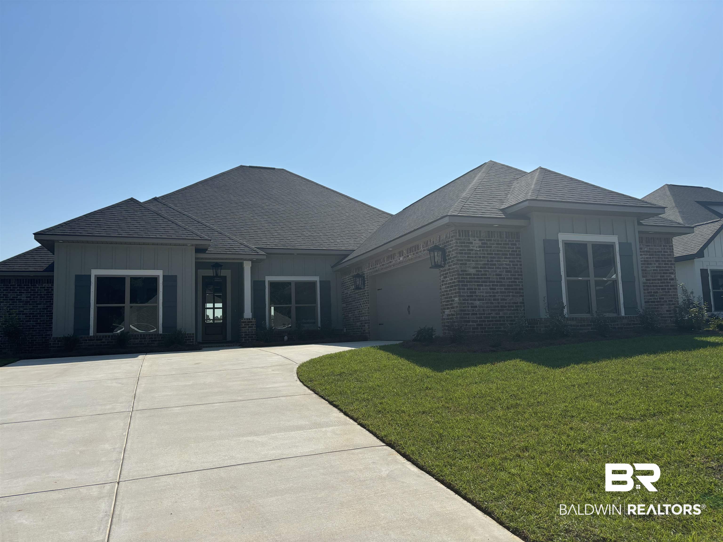 388 Garrison Boulevard Fairhope, AL 36532 - Photo 1 of 34 Prairie-style house featuring a garage and a front lawn