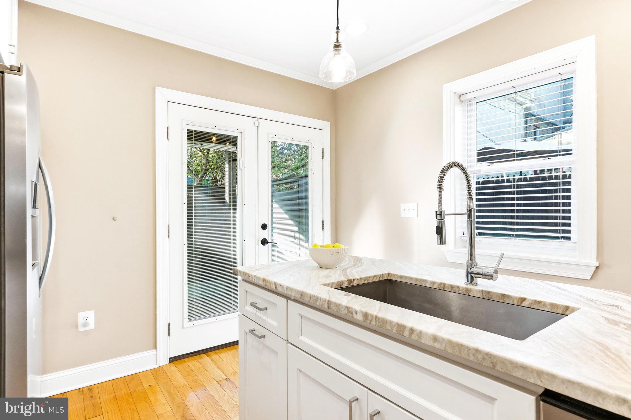404 South Castle Street Baltimore, MD 21231 - Photo 13 of 47 a kitchen with granite countertop a sink and a window
