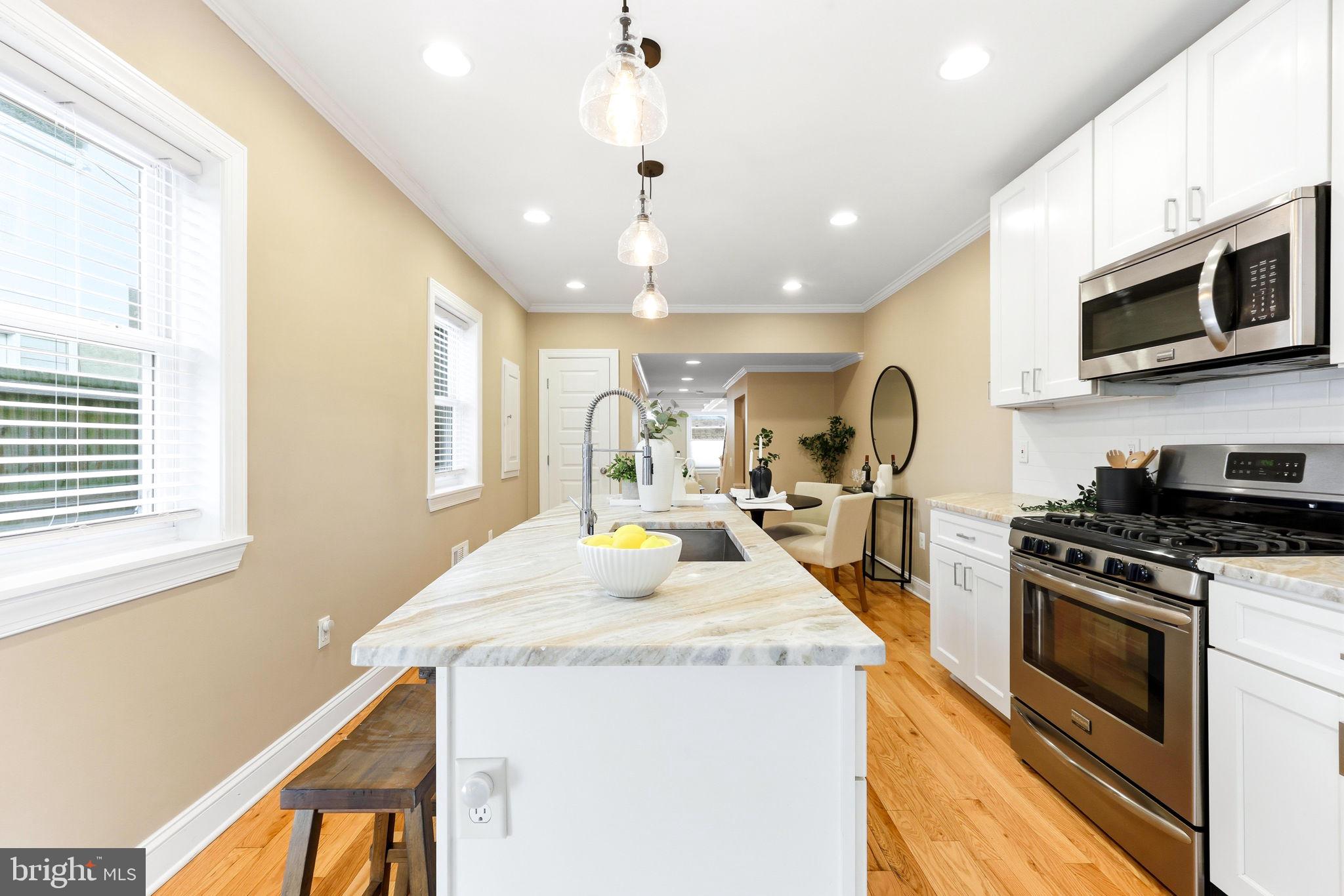 404 South Castle Street Baltimore, MD 21231 - Photo 15 of 47 a kitchen with stove a sink and a microwave