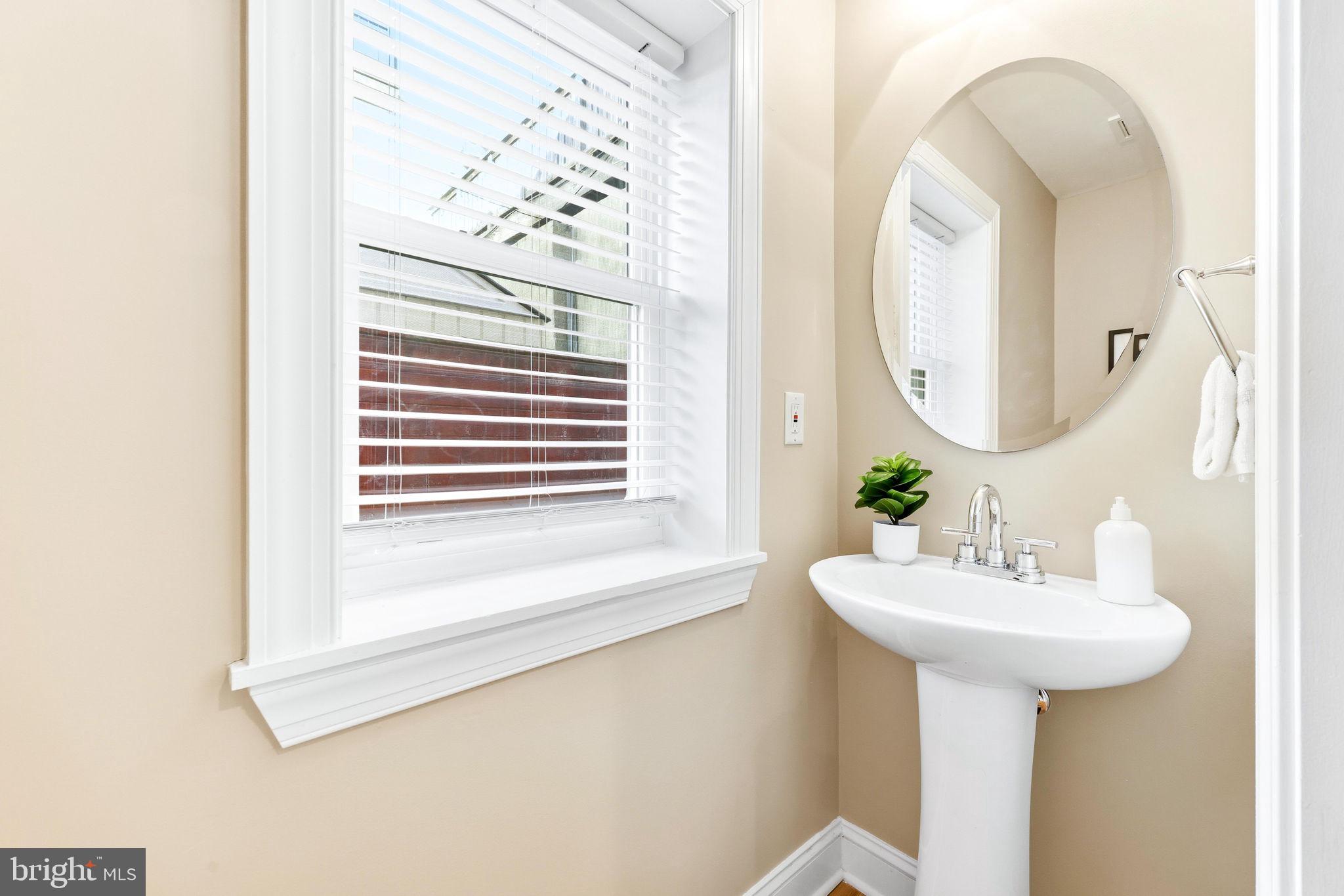 404 South Castle Street Baltimore, MD 21231 - Photo 18 of 47 a bathroom with a sink and a mirror