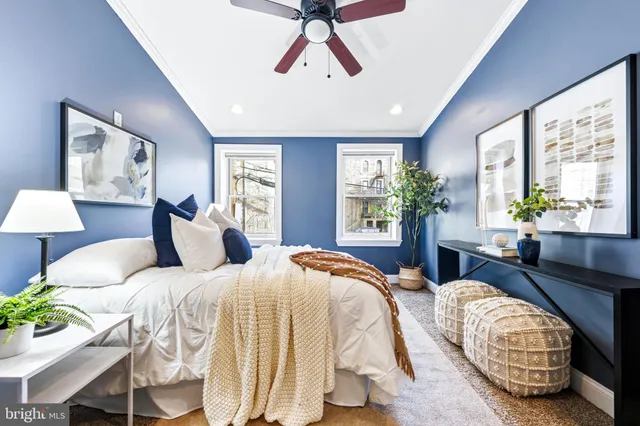 a bedroom with a bed and a large window