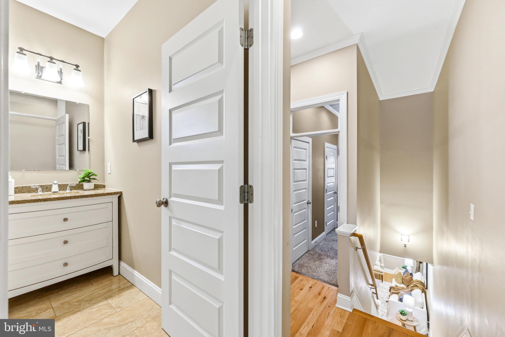 404 South Castle Street Baltimore, MD 21231 - Photo 30 of 47 a bathroom with a double vanity sink and mirror