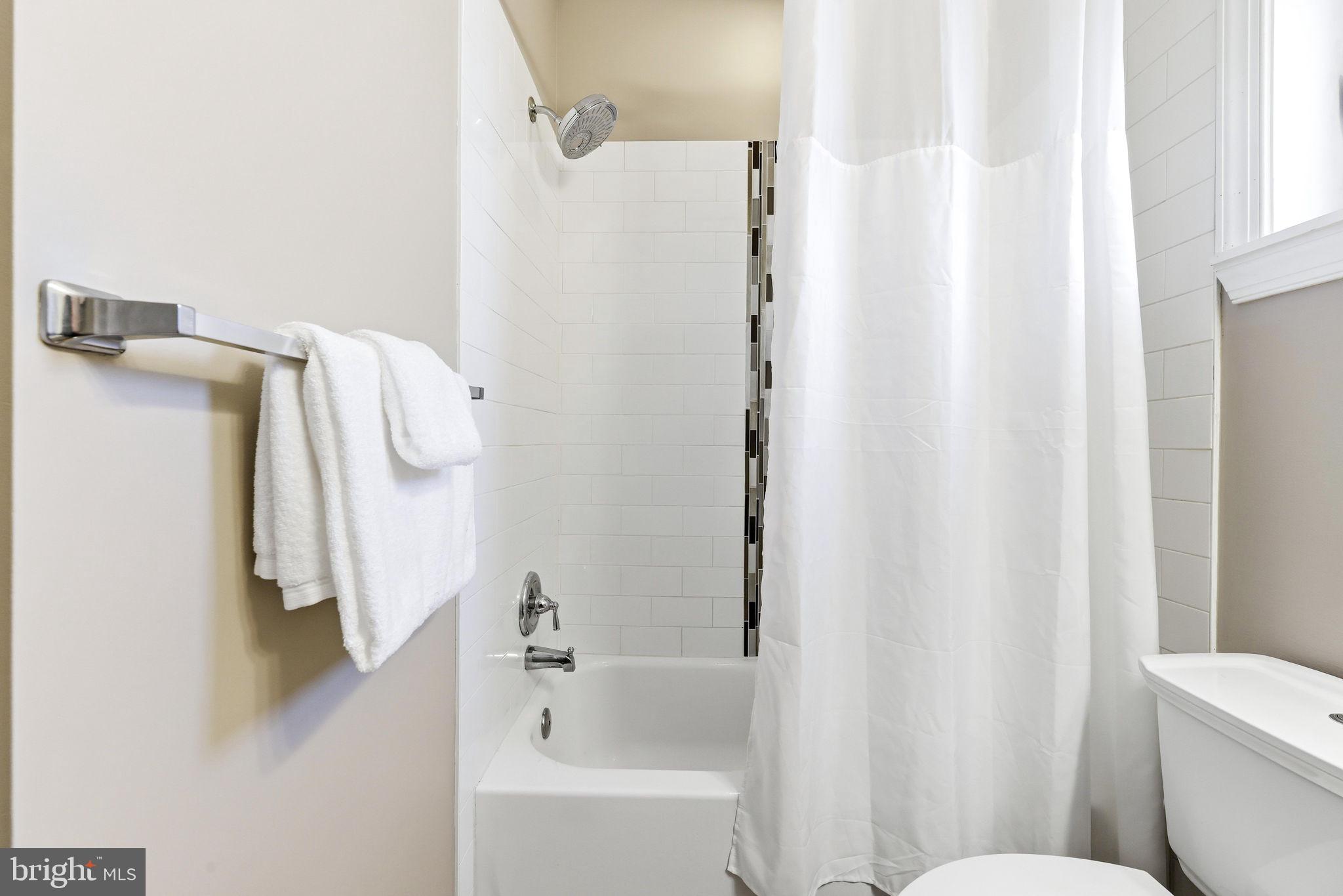 404 South Castle Street Baltimore, MD 21231 - Photo 32 of 47 a bathroom with a shower curtain and a sink