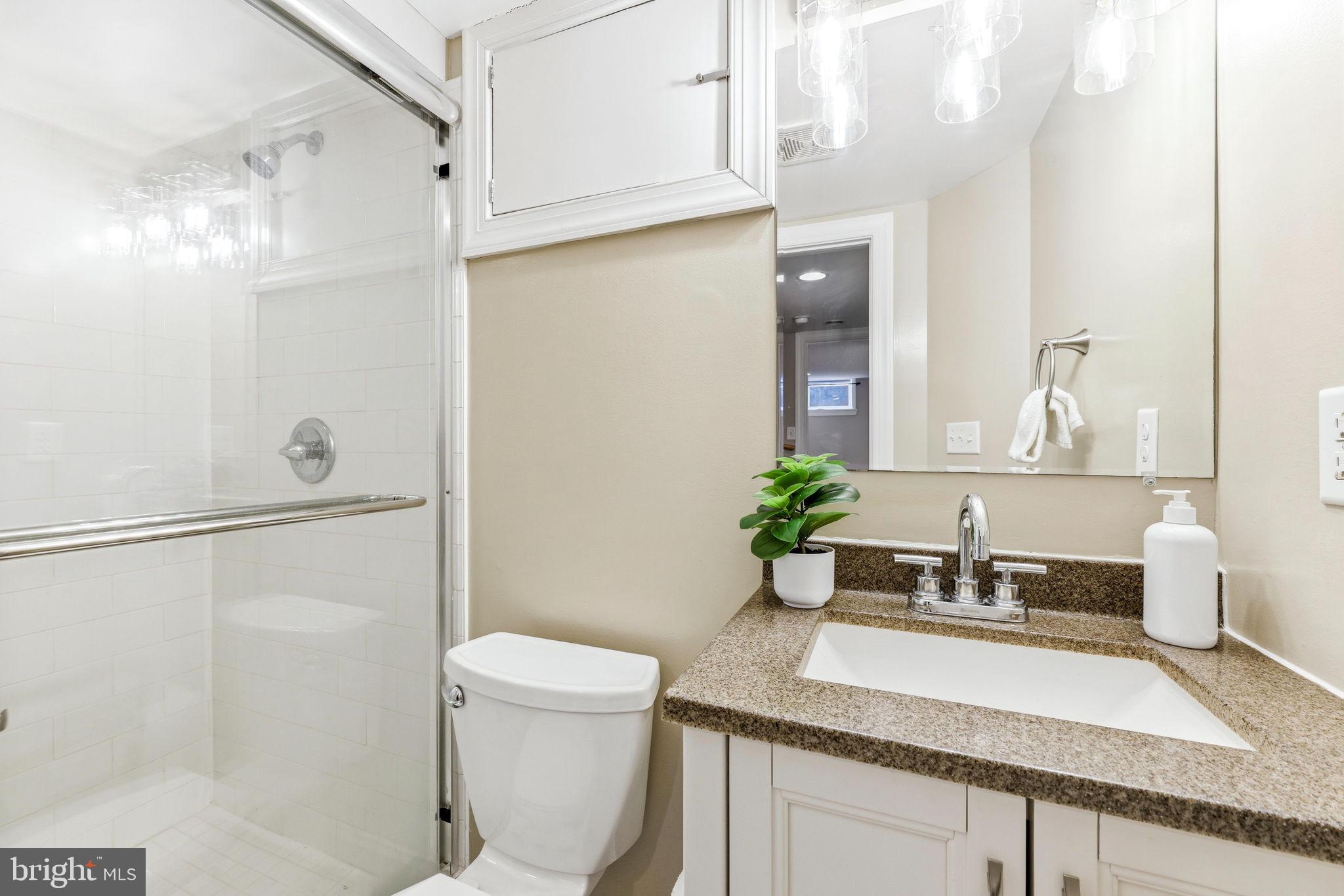 404 South Castle Street Baltimore, MD 21231 - Photo 36 of 47 a bathroom with a granite countertop sink and a mirror