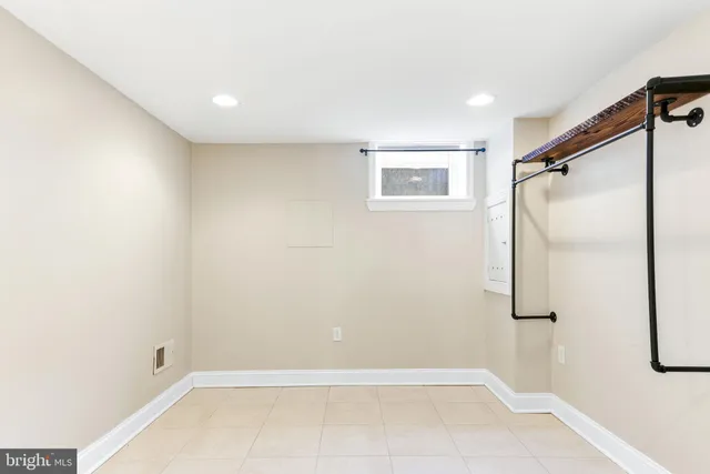 a bathroom with a glass shower door and a sink