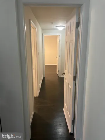 a view of a room with wooden floor and fan