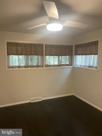 a view of an empty room and wooden floor