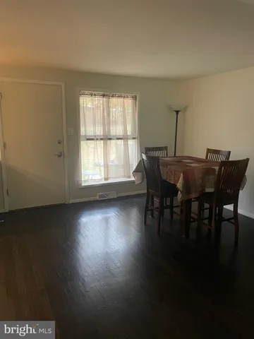 a living room with furniture window and wooden floor