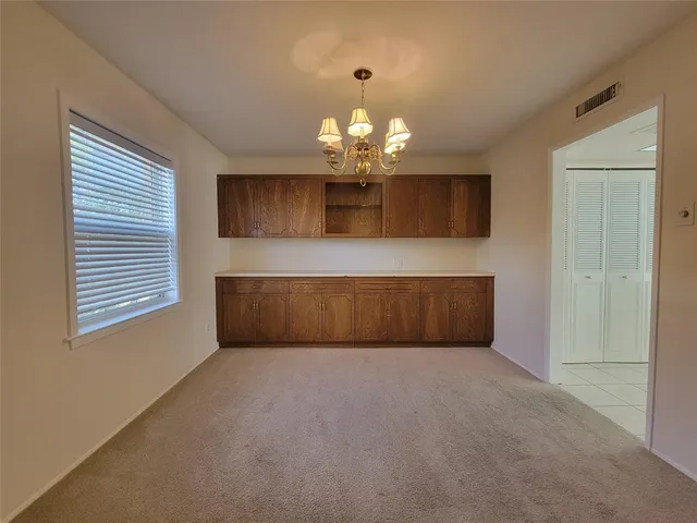 a view of a kitchen with microwave and windows