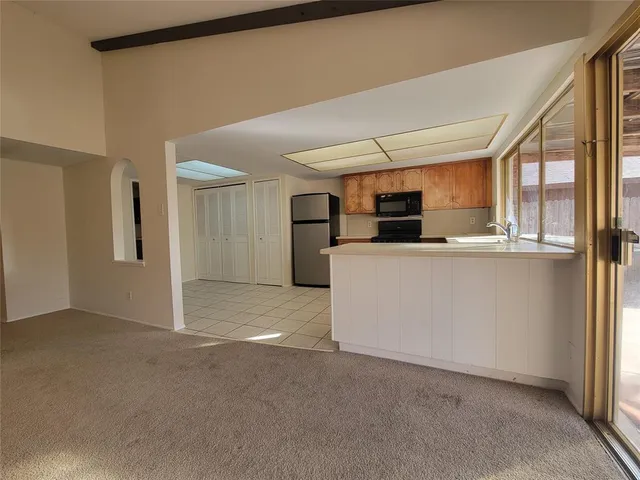 a view of a kitchen with refrigerator and microwave