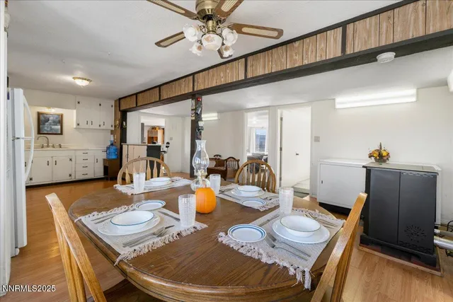 a kitchen with white cabinets stainless steel appliances and wooden floor