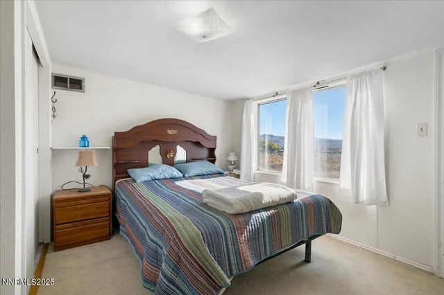 a bedroom with a bed and a yard