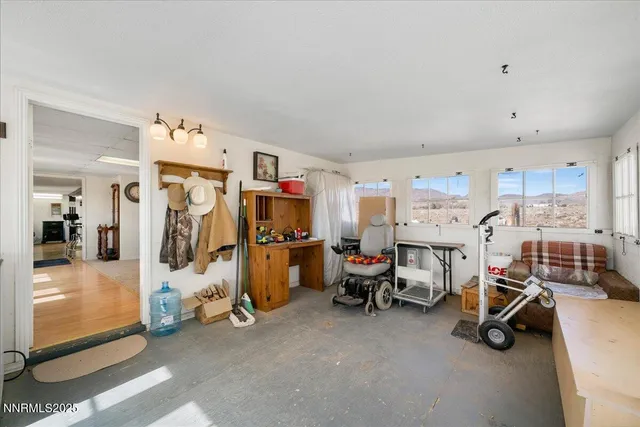 a view of a backyard with chair and table in the patio