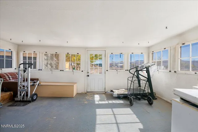 a living room with furniture a flat screen tv and a table