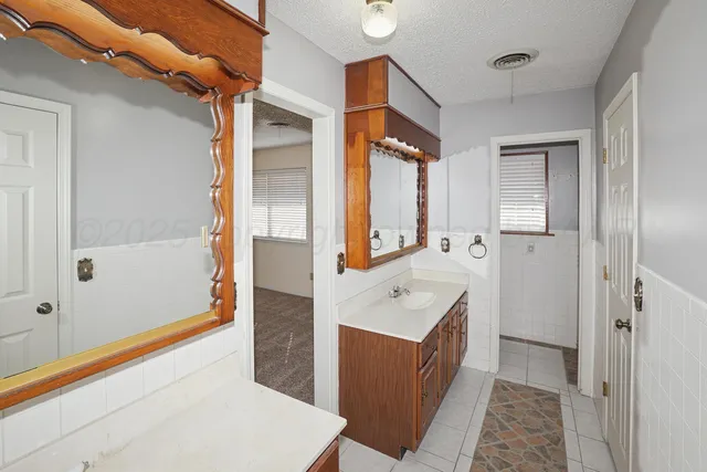 a bathroom with a bathtub a sink and a mirror