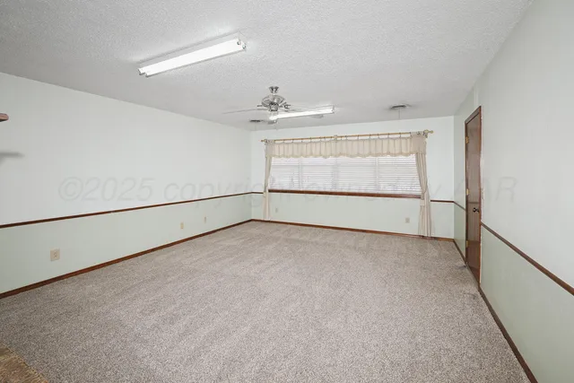 an empty room with a empty space and windows