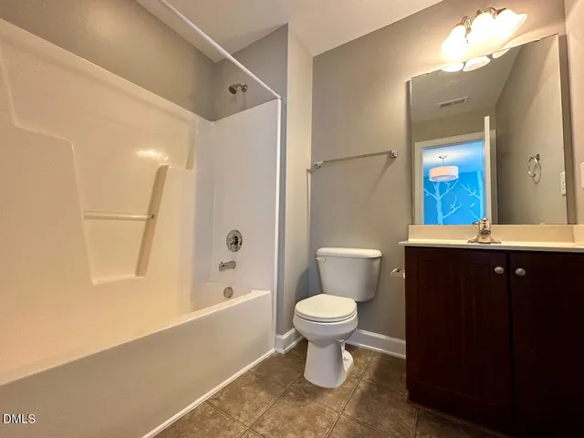 a bathroom with a sink toilet a mirror and shower